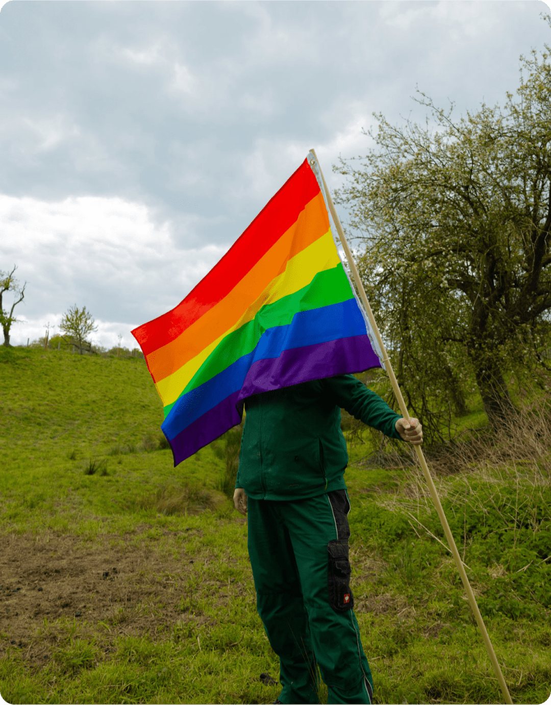 Gay farmer presenting the rainbow wool flag