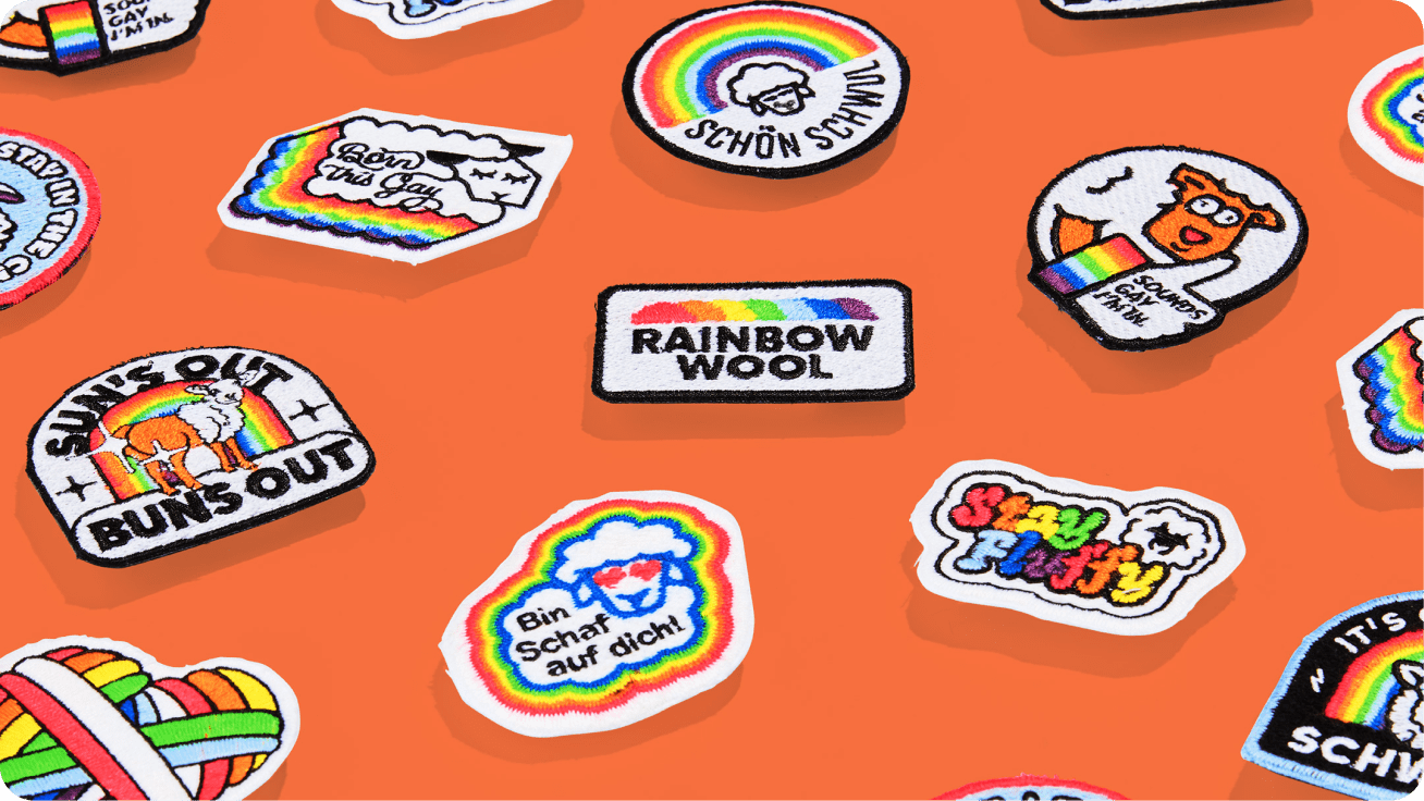 Rainbow wool patches in front of an orange background.